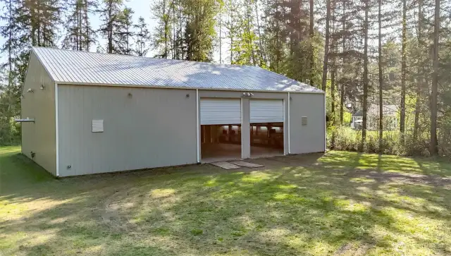 You will notice the house in the background, on the right, behind the line of trees.  There is a pedestrian path the leads from this garage to the house, across the lawn.