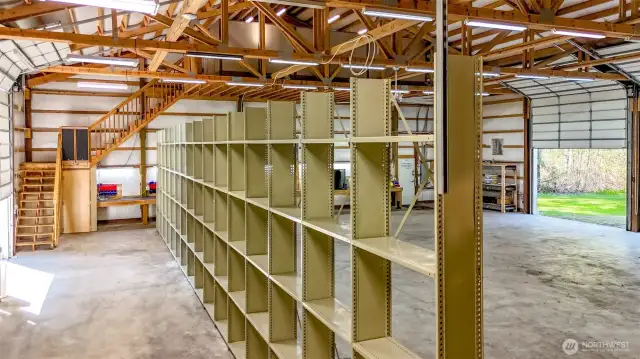 The racking is secure and if it is easy to unbolt from the floor if you want this 5,000 sq foot garage more open.  Staircase leads to office loft.  Tons of lighting-several ceiling fans and there is heating and ventilation.