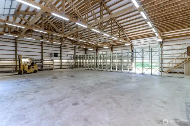 There are several ceiling fans in this 5,000 sq feet garage.  The racking is bolted to the floor and if you want it removed, it would be easy to unbolt.  The propane tank is owned and located outside above ground, for heating this garage!
