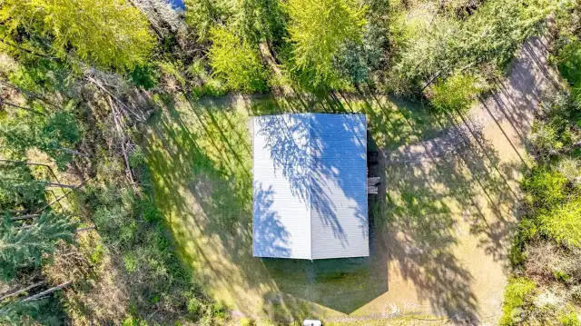 The 5,000 sq feet garage has a driveway leading from Christansen-Muck Road.  Look at all the turn around space for R.V. and long haul trucks!  The third driveway on the left is overgrown and leads to the other street to the south.