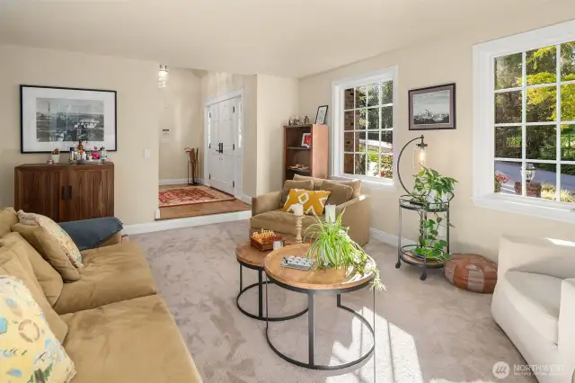 A light filled, warm, relaxing, private home.  A traditional floorplan with large rooms featuring a living room, family room, dining room and eating nook. Here is the inviting and warm living room framed by one of two fireplaces with a custom mantel and displays the details of new wood trim you see throughout the home.