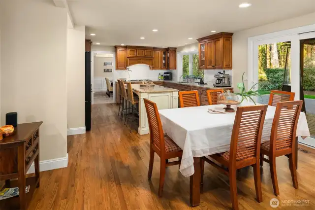 The kitchen opens to the spacious eating nook adjacent to the comfortable, sunken family room with a beautiful gas fireplace framed by large windows with plantation shutters and features built-in surround sound speakers.