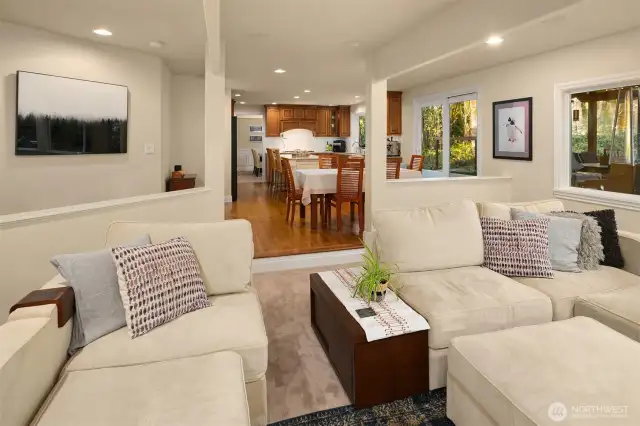 The kitchen opens to the spacious eating nook adjacent to the comfortable, sunken family room with a beautiful gas fireplace framed by large windows with plantation shutters and features built-in surround sound speakers.