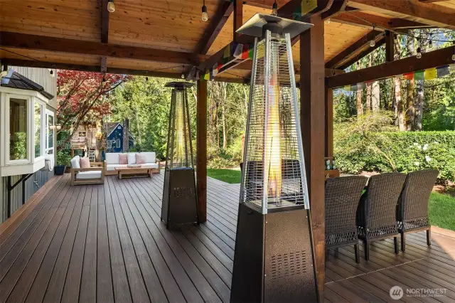 Off of the family room and kitchen space is the massive TimberTech deck with a covered area with outdoor speakers ~ perfect for Summer BBQ's, entertaining family or friends, lounging, and dining al fresco.