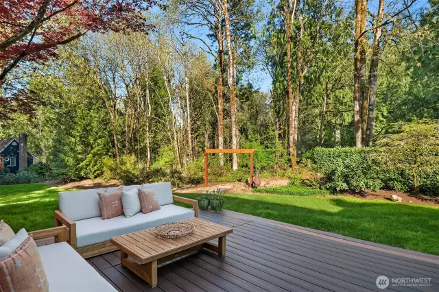 Off of the family room and kitchen space is the massive TimberTech deck with a covered area with outdoor speakers ~ perfect for Summer BBQ's, entertaining family or friends, lounging, and dining al fresco.