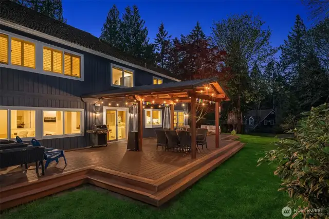 Off of the family room and kitchen space is the massive TimberTech deck with a covered area with outdoor speakers ~ perfect for Summer BBQ's, entertaining family or friends, lounging, and dining al fresco.