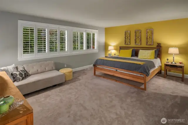 The lavish primary suite overlooks the back yard through plantation shutters.  Adjacent is the circular 5-piece en suite bathroom with heated floors, jetted tub and a large walk-in closet.