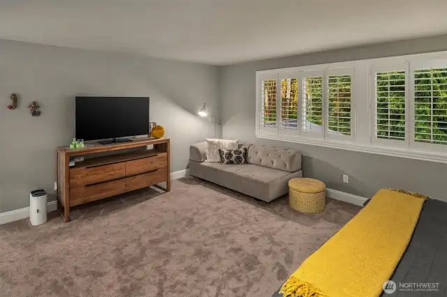 The lavish primary suite overlooks the back yard through plantation shutters.  Adjacent is the circular 5-piece en suite bathroom with heated floors, jetted tub and a large walk-in closet.