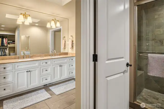 The 5-pieces en suite bath features a skylight, dual vanity with granite counters, heated tile floors, oversized shower with body jets, bench and nook, a deep jetted tub and a huge walk-in closet with a circular layout providing two accesses to this space.