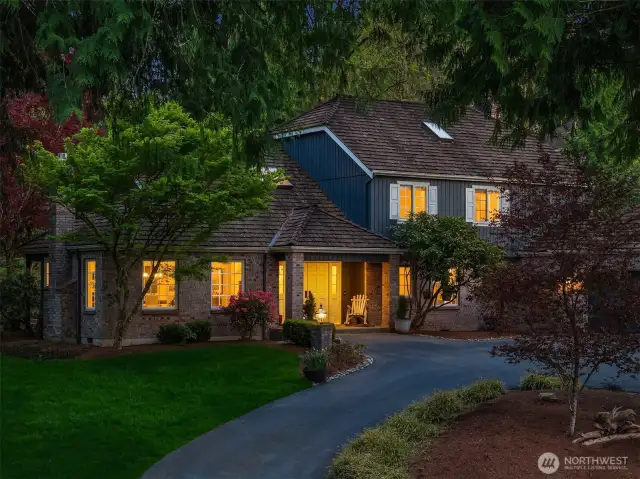 The home features a circular driveway, and the lot displays a beautiful color-contrast in the variety of trees and shrubs in the landscaping. Additional features and upgrades of the home include a commercial-grade cedar shake roof, wired for a generator, security system, and the Homeowners have had the crawlspace completely renovated.