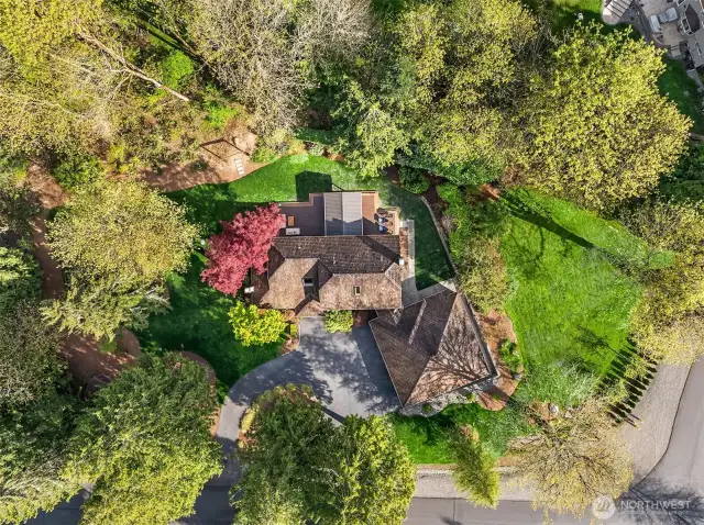 The home features a circular driveway, and the lot displays a beautiful color-contrast in the variety of trees and shrubs in the landscaping. Additional features and upgrades of the home include a commercial-grade cedar shake roof, wired for a generator, security system, and the Homeowners have had the crawlspace completely renovated.