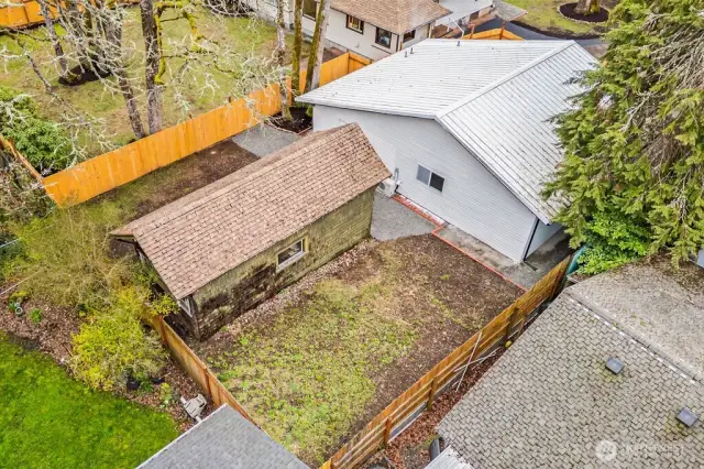 Back of the home. Outbuilding is included in this sale.