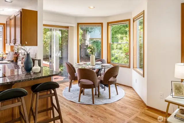 The breakfast nook leads out via the sliding door to the backyard deck, storage unit and yard.