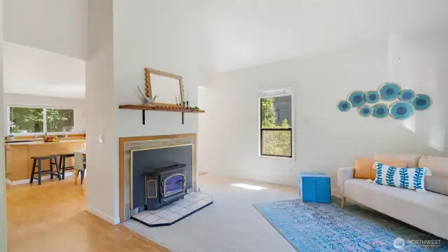 Just beyond the fireplace, the kitchen and dining area offer their own defined spaces while still feeling connected. It’s a layout that gives everyone room to breathe without losing that sense of togetherness.