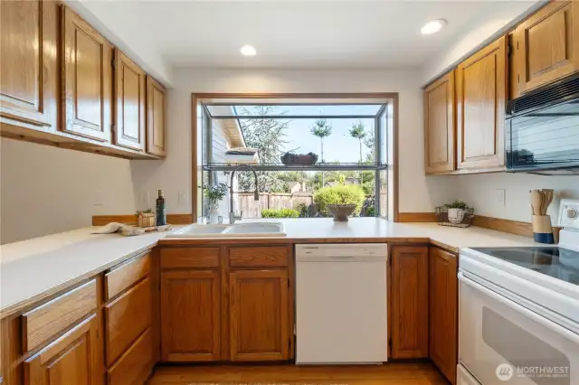 Kitchen with garden window overlooking garden space and enterainment area.