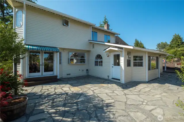 Rear yard with beautiful stone pavers accessed from the dining room and rec room. 220 power in this area available for potential hot tub use.