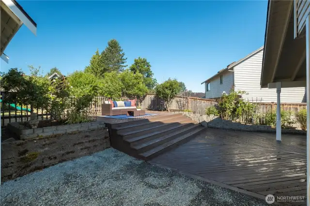 Elevated deck leading to fenced-in yard.