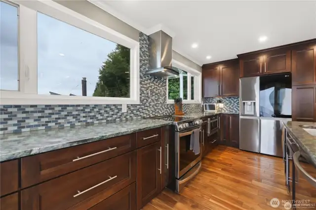 This chef's kitchen is a masterpiece of design and efficiency. It features high-end appliances, ample counter space, and custom cabinetry.
