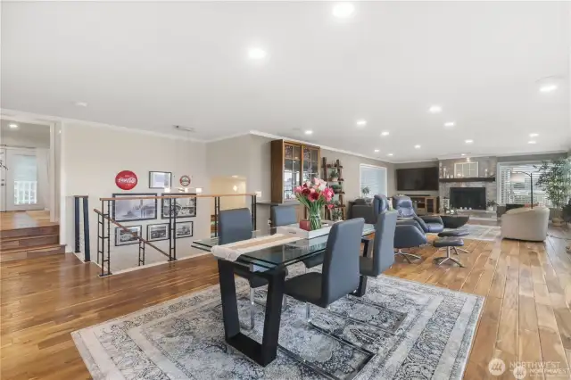 An open concept living space offers warmth, spaciousness, and seamless flow-a perfect blend of comfort and contemporary design. At the heart of the space is a beautiful gas fireplace serving as both a visual focal point and a cozy gathering spot.