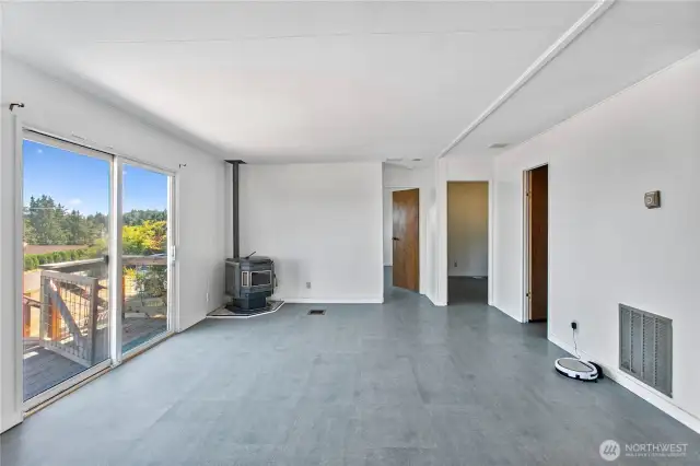 Family Room with pellet stove and deck off sliding glass doors