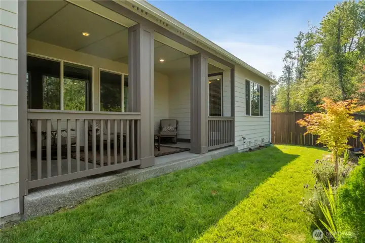 Fully landscaped yard with low maintenance plants and trees