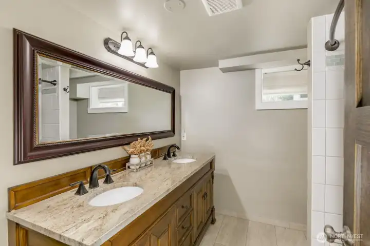 Newly renovated downstairs bathroom with double sinks.