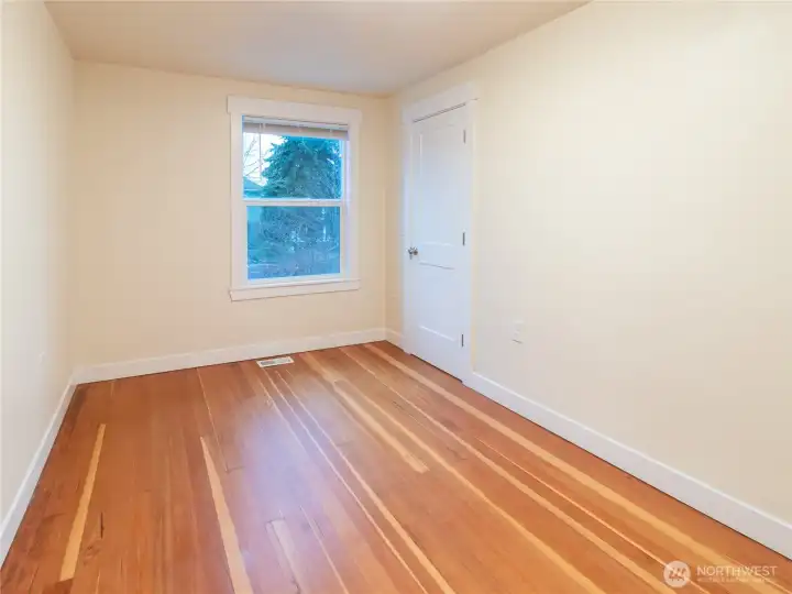 Bedroom 1 has gorgeous flooring, fresh paint, newer craftsman style trim and a decent sized closet.