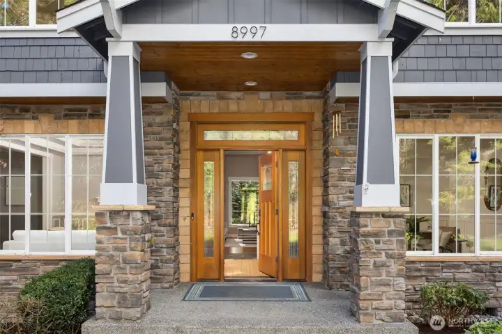 Stone, wood, and natural light come together to create a welcoming Northwest entrance.