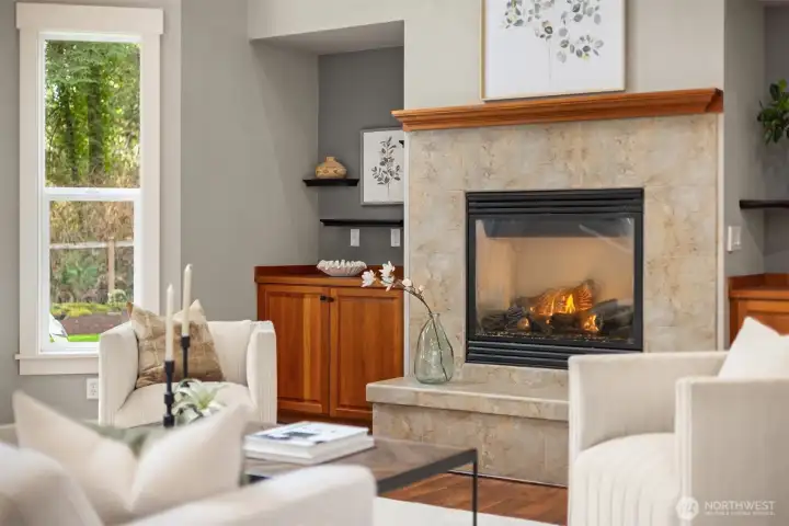 Gas fireplace with tile surround, built-in cabinetry, and warm natural finishes create an inviting focal point in the living space.