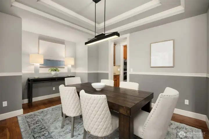 Formal dining room with tray ceiling and direct access to the kitchen through a convenient butler’s pantry — ideal for entertaining and everyday flow.
