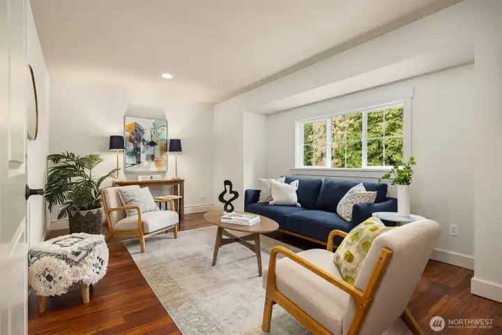 Upstairs is this lovely additional living area with French doors and hardwood floors. This makes for a perfect second office or media room.