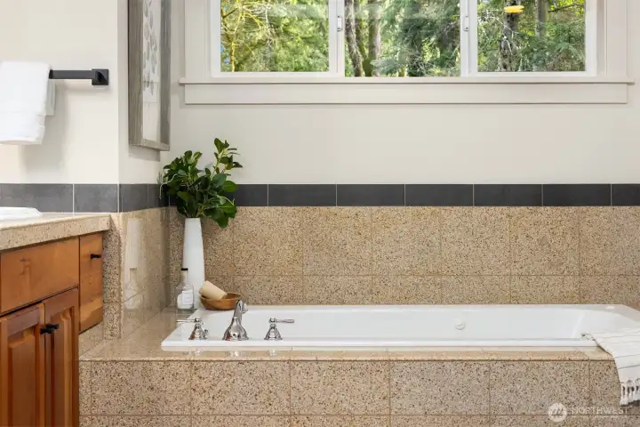 Primary bath soaking tub designed for relaxation with natural light and spa-like feel.