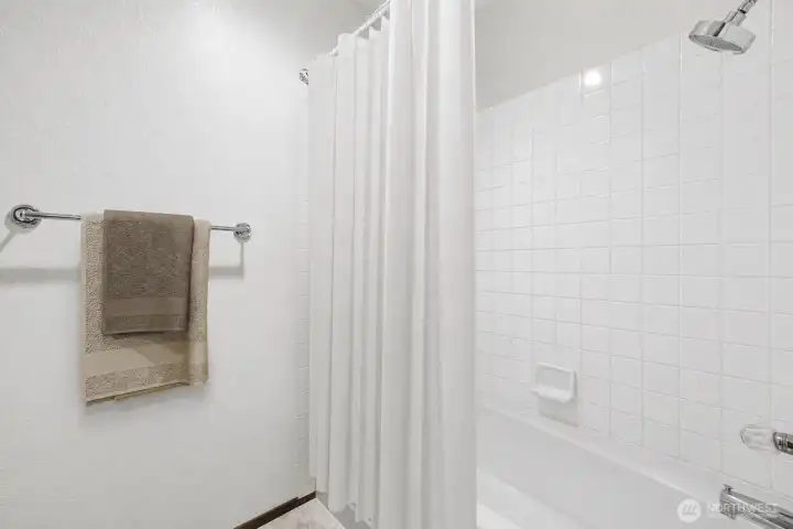 Lower-Level Bonus Room: Flexible space shown as wine storage with kitchenette