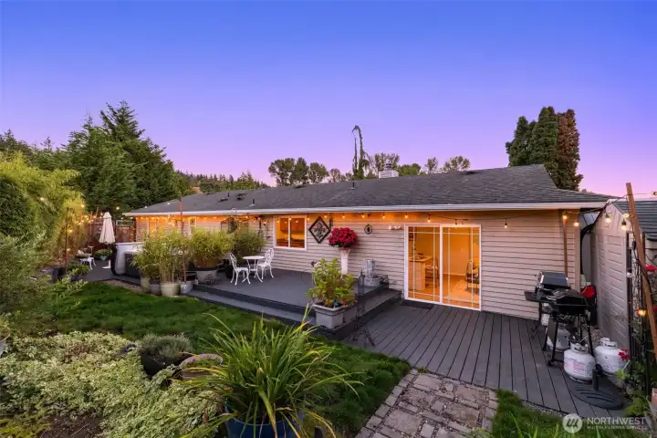 Evening view of the home framed by lush landscaping.