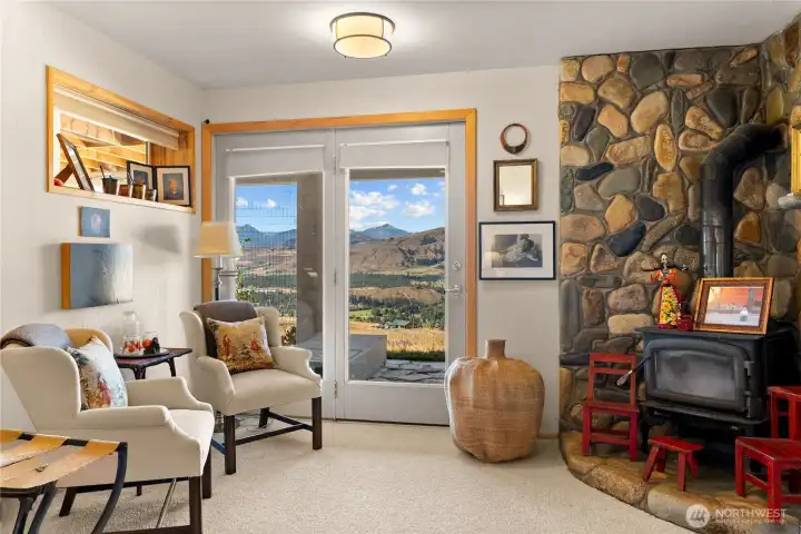 Bedroom 1, downstairs with private entrance and river rock wood stove.