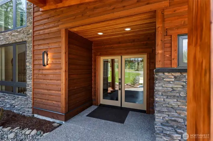 covered entrance in wood and stone finishes