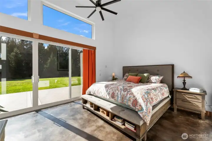 Primary suite with vaulted ceilings, huge slighting doors leading out to the deck