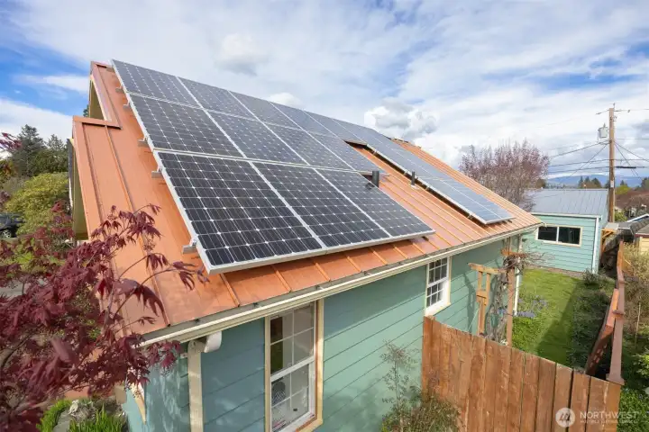 The metal 50 year standing seam metal roof was placed in 2008, and the solar panels were placed on the home in 2015, and they pay less than $8 per month for their power.