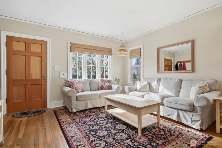 Welcome inside this beautiful home! The living room is spacious and open to the dining area. The original oak hardwood floors are in good condition.