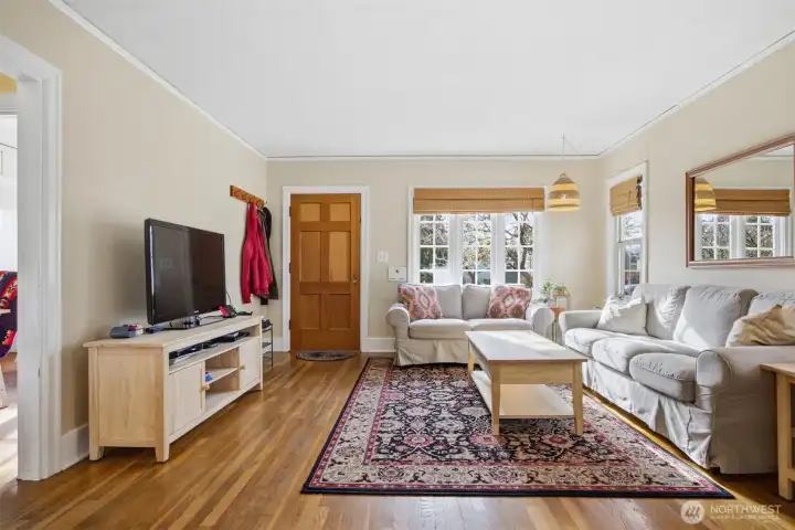 The home has large windows and the sunlight streams into the large living room.