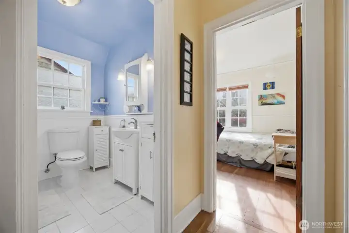 The full bath is between the primary and 2nd bedroom on the main floor. The fir floors in this bedroom are beautiful!