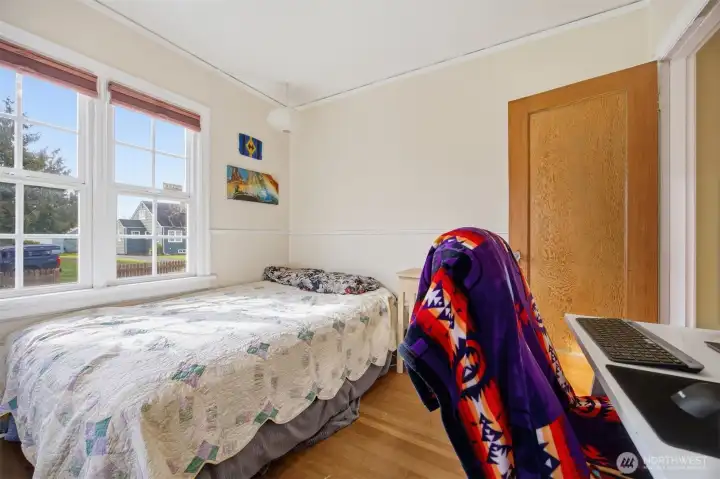 The second bedroom looks out toward the front yard and also has large windows.