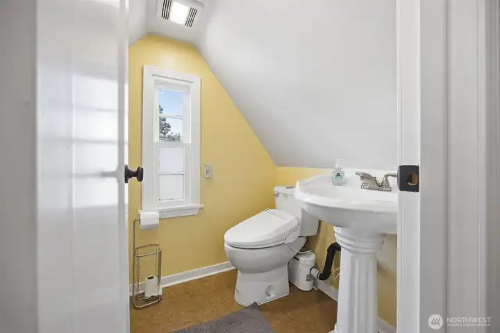The upper half bath has a macerater toilet and vanity sink.