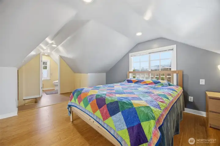 Looking across the bedroom portion of the 2nd story with the half bath beyond.