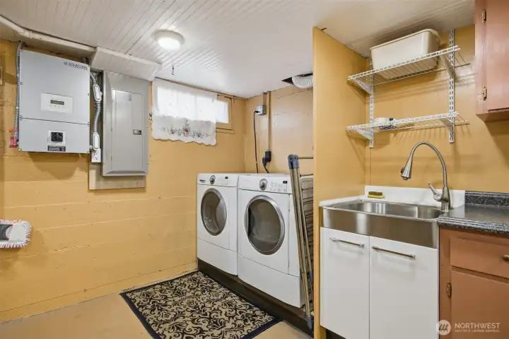 The washer and dryer stay with the sale of the home and the solar system installed in 2015 is housed next to the electrical panel which was installed in 2000. There is a laundry sink which is very handy, too.