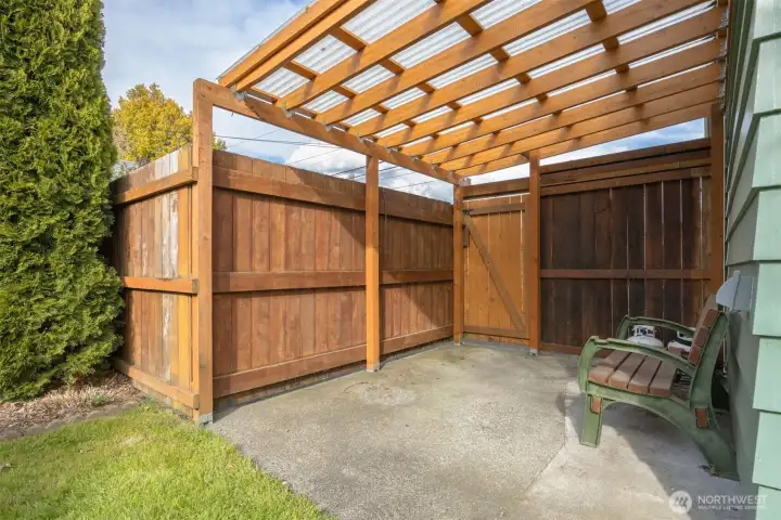 There is a lovely covered patio area off the garage shop in the back yard.