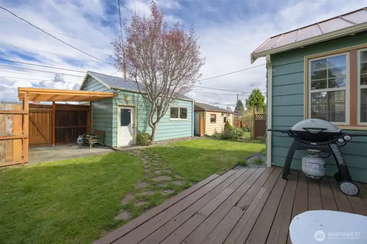 There is a great back deck just off the dining and kitchen area, and ideal for BBQ's! The stone walkway leads to the garage shop and the covered patio area.