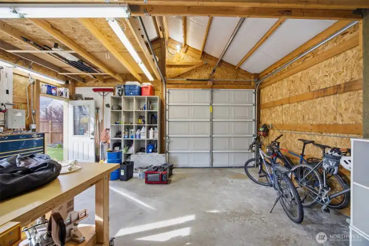 The garage is spacious and has room for one vehicle and a work shop area.