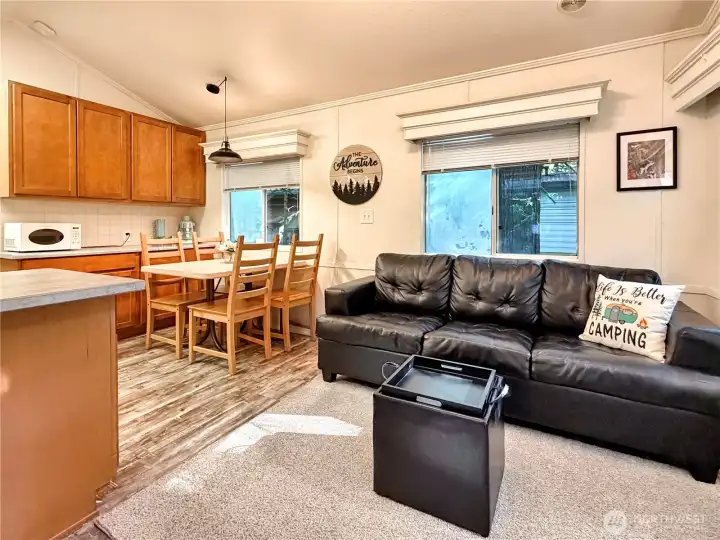 Engineered hardwood flooring throughout the main living spaces and bedroom.