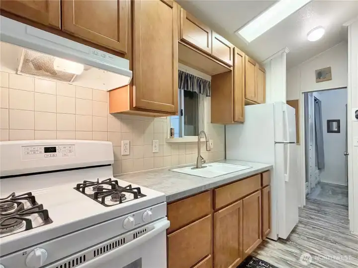 Updated propane stove, new kitchen faucet over the double basin sink and soft-close cabinetry and drawers.
